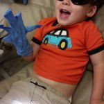 Photo of a young, smiling pediatric dental patient wearing cool shades