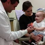 Photo of a toddler and mother, meeting pediatric dentist Dr. Andy