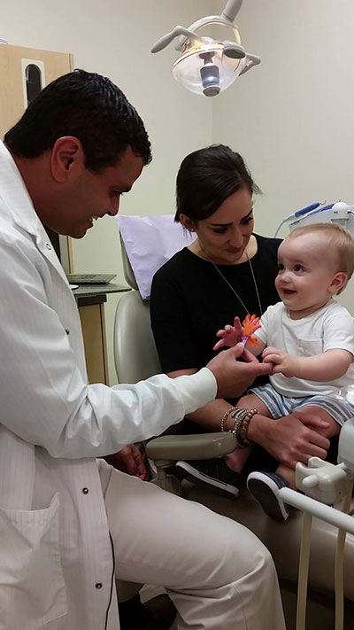 Photo of a toddler and mother, meeting pediatric dentist Dr. Andy